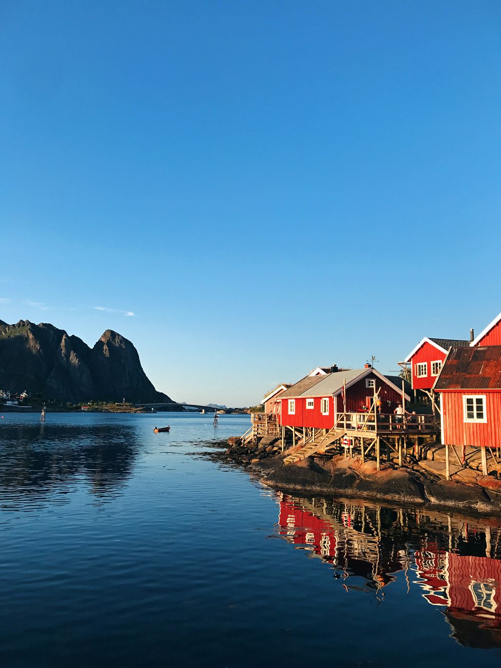 Norwegian wooden cabins over clear fjord waters
