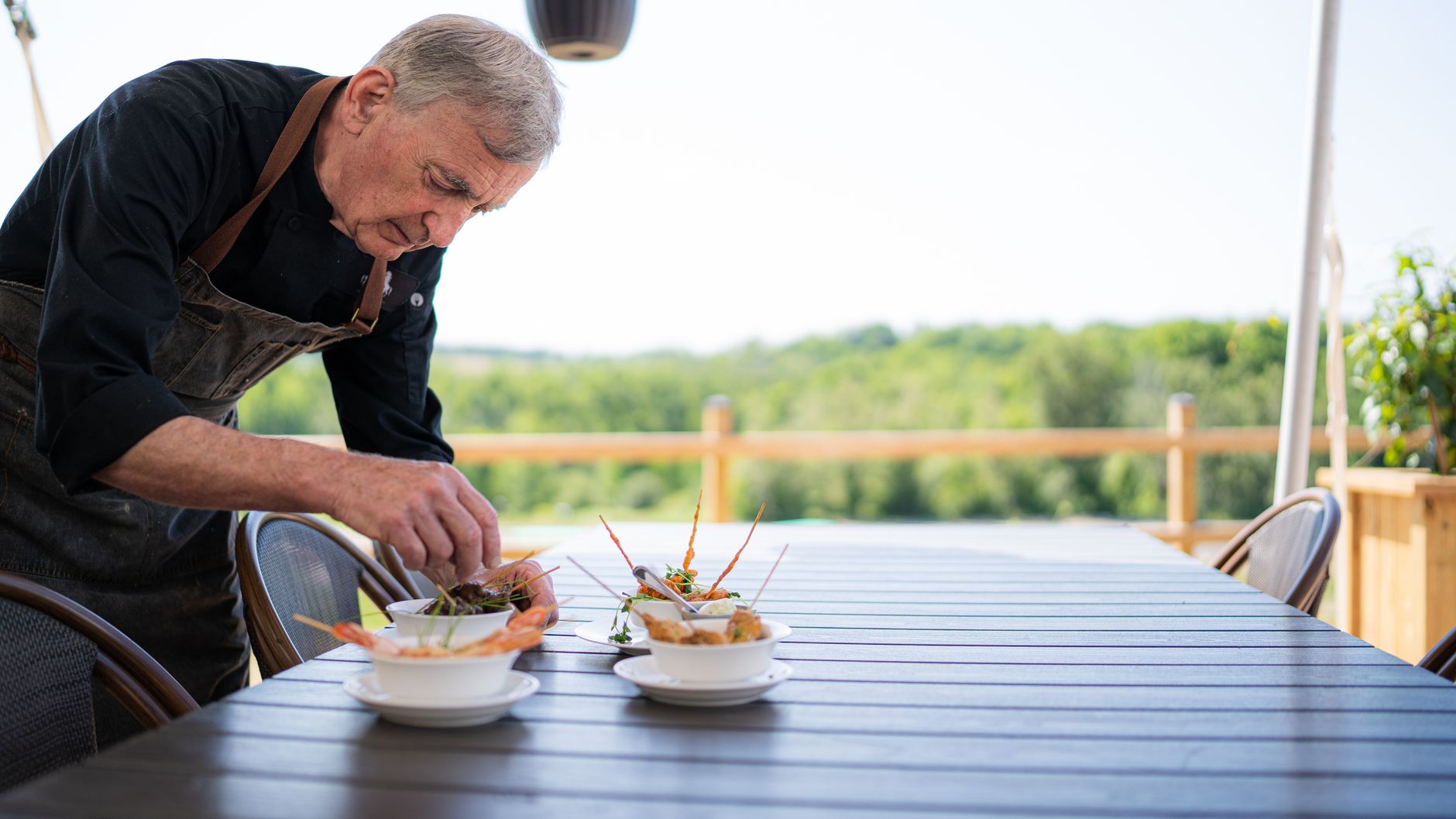Chef plating local heirloom ingredients outdoors